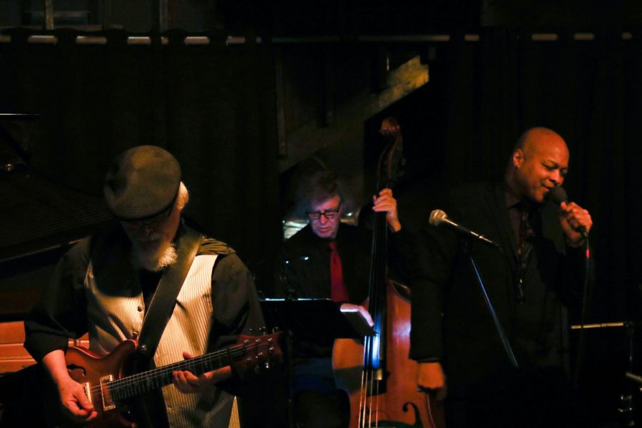 Instructors perform at Rico’s Pub House on Saturday. Horace Alexander Young sings, Brad Ard plays guitar and Dave Snider plays bass.