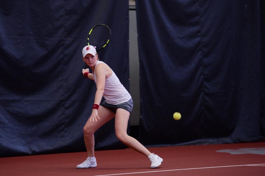 Sophomore Michaela Bayerlova watches the ball approach her racket April 12 at Hollingbery Fieldhouse.