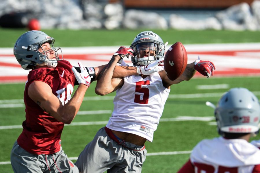 Sophomore cornerback Derrick Langford and redshirt freshman wide receiver Rodrick Fisher compete for a pass during practice on March 21 in Martin Stadium.
