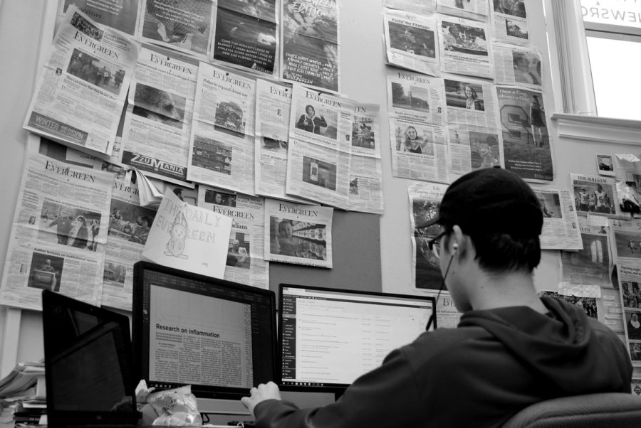 Layout editor Ty Eklund sits under a wall full of old newspapers each night as he uses Adobe InDesign to lay out the front page. They’re meant to showcase great past layouts while offering layout editors inspiration for what they can do.