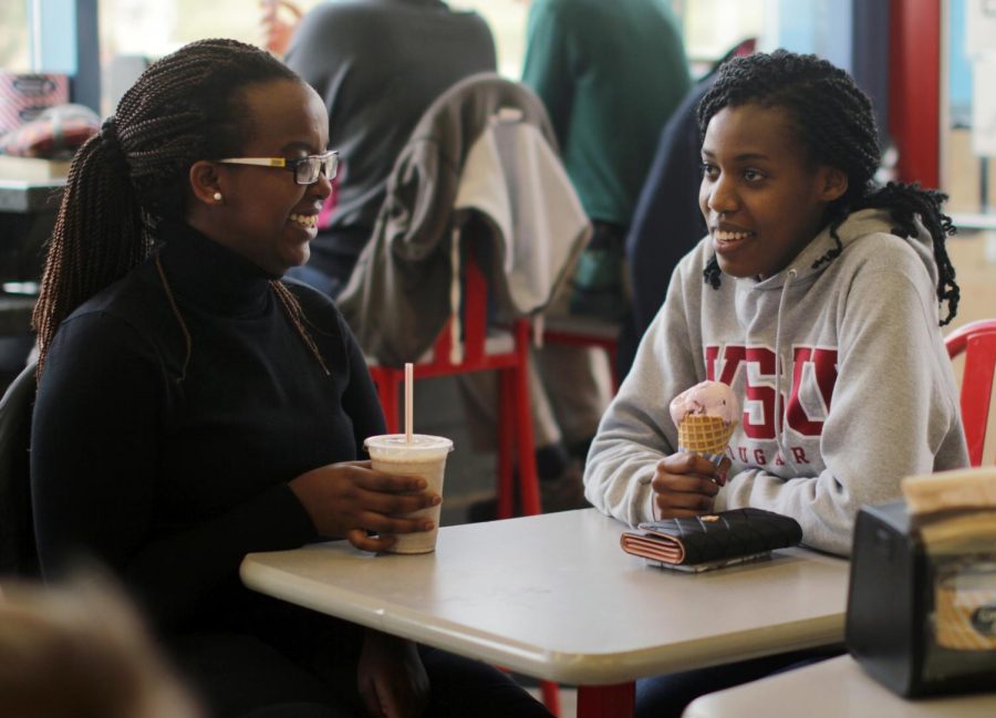 Linda Umwali, left, and Ellen Mahoro talk during a Thursday, April 4 visit to Ferdinands Ice Cream Shoppe. The stop has become something of a tradition for the friends, who hail from the same secondary school in Rwanda.