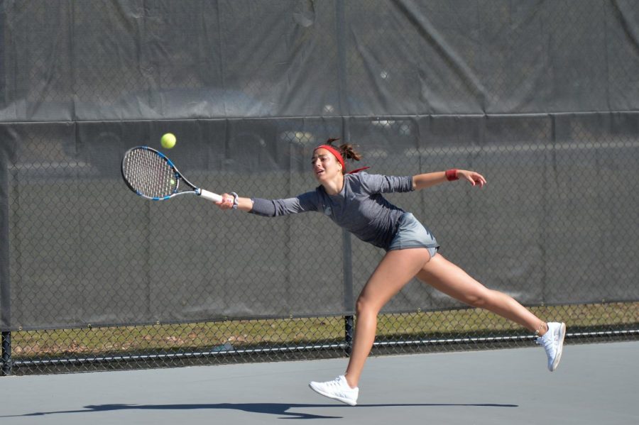 Senior+Tiffany+Mylonas+hits+the+tennis+ball+back+towards+her+opponent+on+Mar.+31+at+the+Outdoor+Tennis+Courts.+The+game+against+Arizona+resulted+in+a+6-1+win+for+the+Cougars.