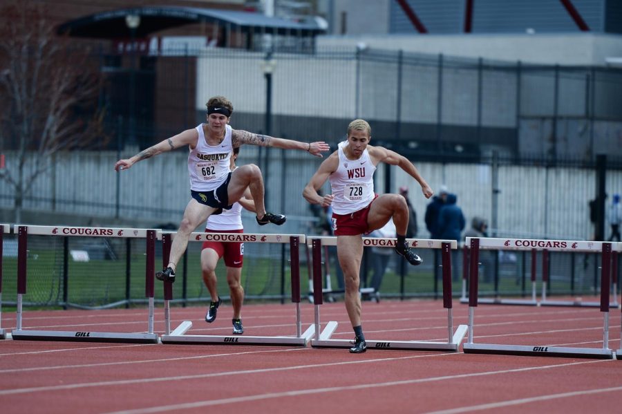 Sophomore Austin Albertin from Spokane Community College, left, and senior Christapherson Grant compete in the men 400-meter hurdles during the Cougar Invitational on April 27 at Mooberry Track. Grant finished first in the event with a time of 53.96.