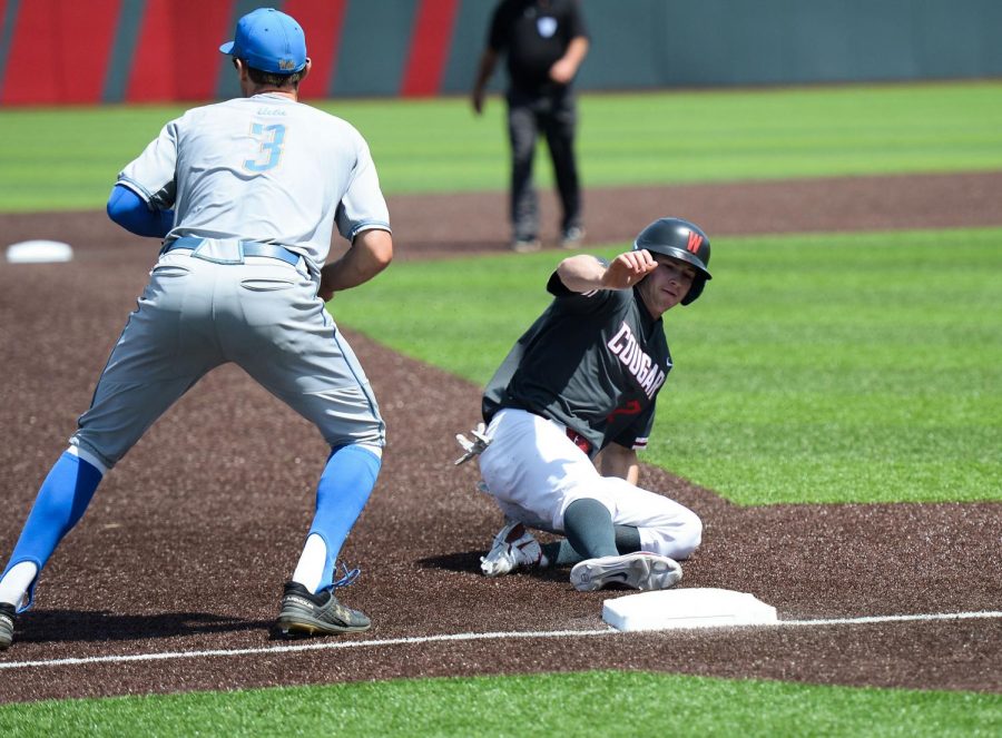 Outfielder Danny Sinatro slides into third base during the game against UCLA on May 12. 