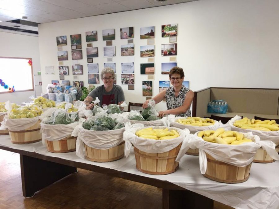 Monica Hardie and Gail McNeilly, lead volunteers at the Colfax Food Pantry, prepare donated food for distribution.