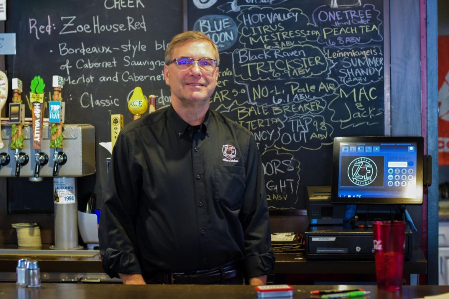 Mike Wagoner, Zoe manager and owner of Cougar Country, smiles behind the counter and talks about the future of Cougar Country Drive-In on Monday afternoon at Zoe Coffee-house and Pub.