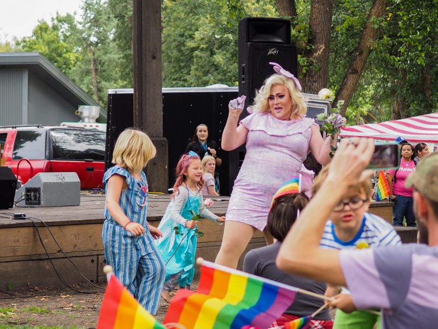 Aquasha DeLusty, drag queen, dances with children during her performance at the Palouse Pride festival on Saturday.