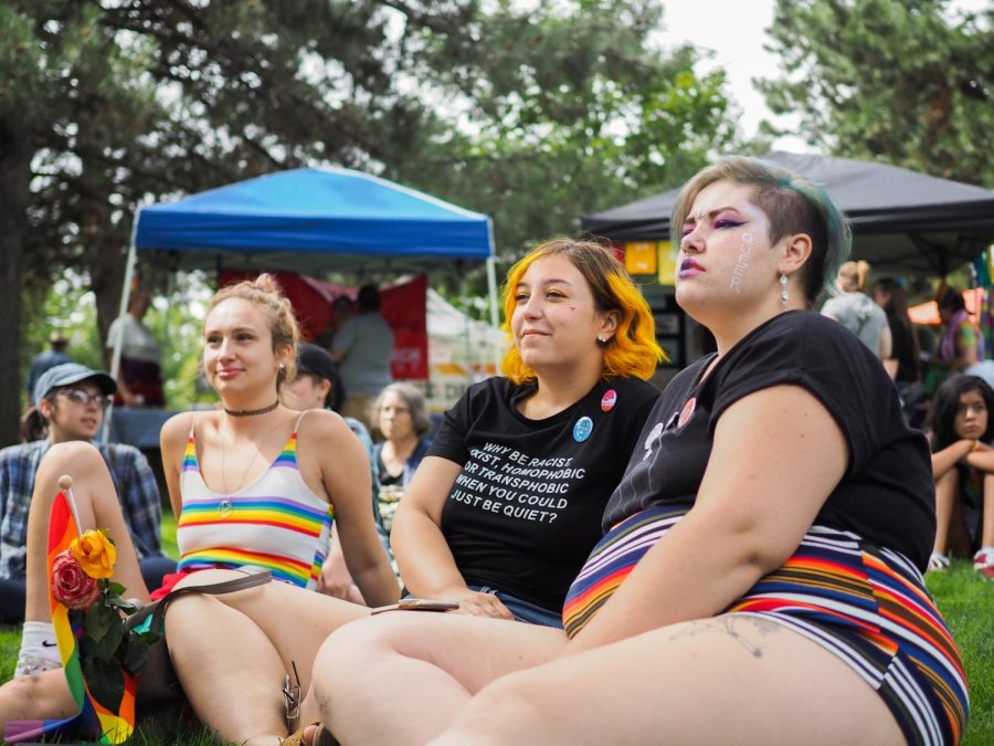From left to right: Madeleine Clow, Zoey Rambery, and Autumn Barnhill sit at festival grounds and watch performers at Palouse Pride. Zoe has attended Palouse Pride festivals since she was 14 years old.