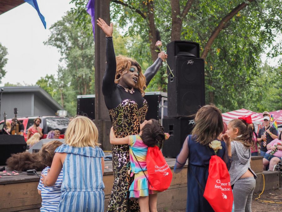 Madame LeRue, drag performer, performs at Palouse Pride as children embrace her, on Saturday afternoon.