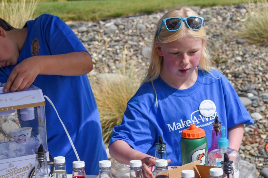 Shay Connell, fundraiser organizer and Pullman resident, prepares a snow cone Wednesday afternoon to raise money for the Alaska & Washington chapter of Make-A-Wish. Last year, Connell and two of her friends collected more than $4,300 for the organization.