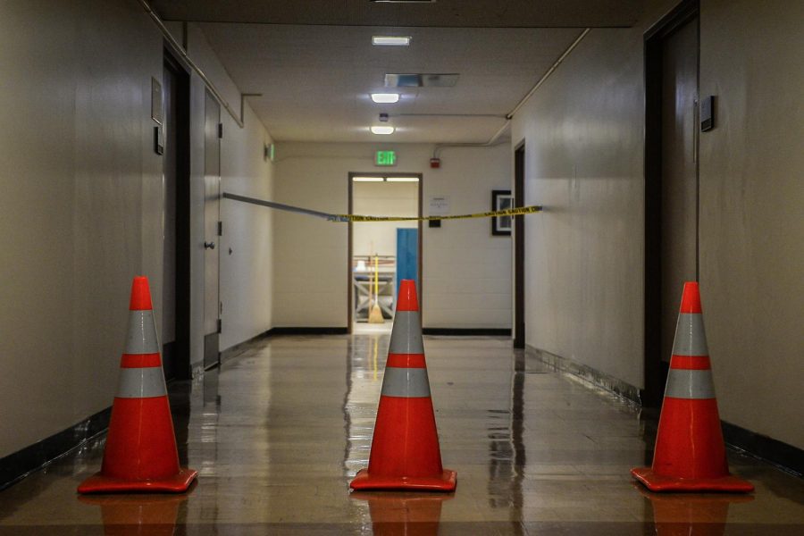 Cones and caution tape block the hallway in the southwest corner of the ground floor on Wednesday at Sloan Hall.
