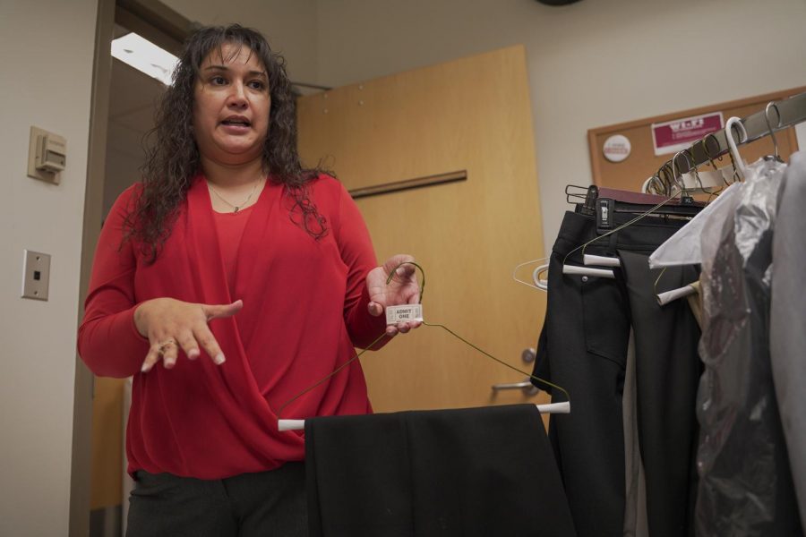 Maria de Jesus Dixon, assistant director for the Academic Success and Career Center, shows off some clothes students could use at interviews Wednesday at the Lighty Student Services Building.