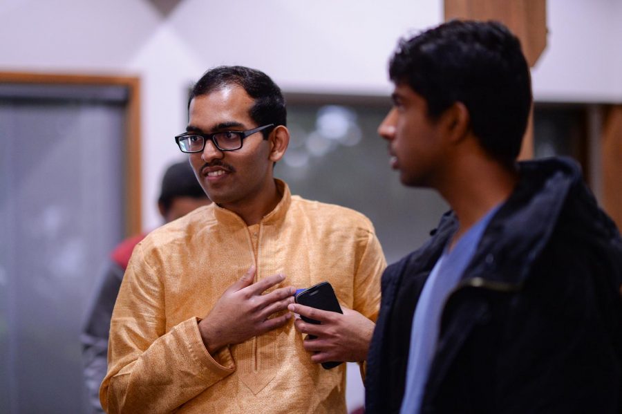Arun Imayakunar, Treasurer of Indian Students Association, chats with other attendees at the welcoming party Sunday night at the Chinook Community Center.