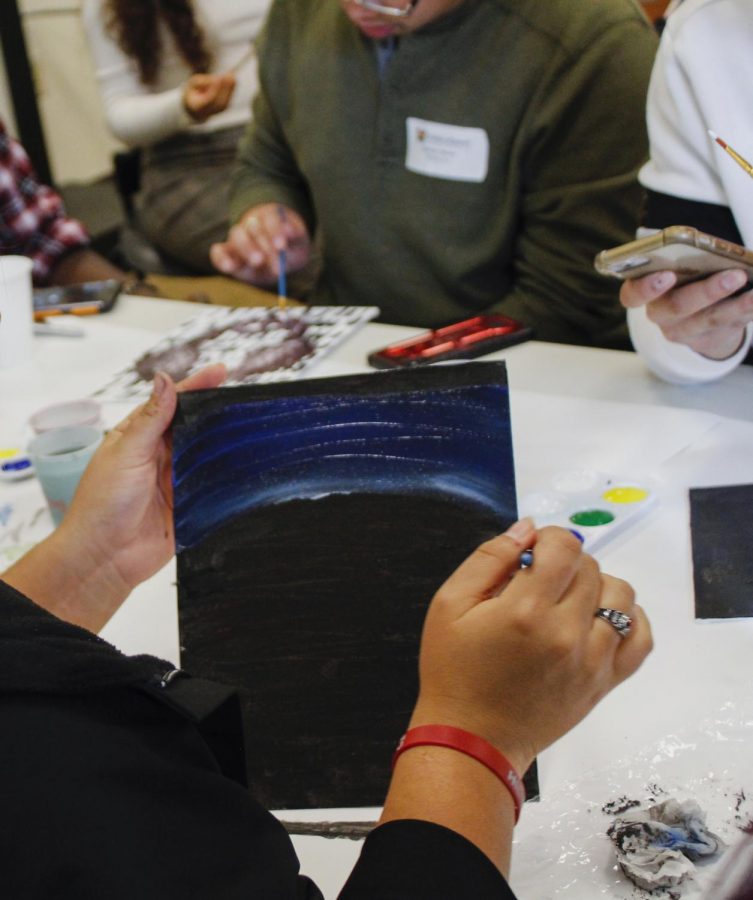 A WSU student paints a gradient at the UndocuQueer Conference on Saturday afternoon at the UW Samuel E. Kelly Ethnic Cultural Center in Seattle.
