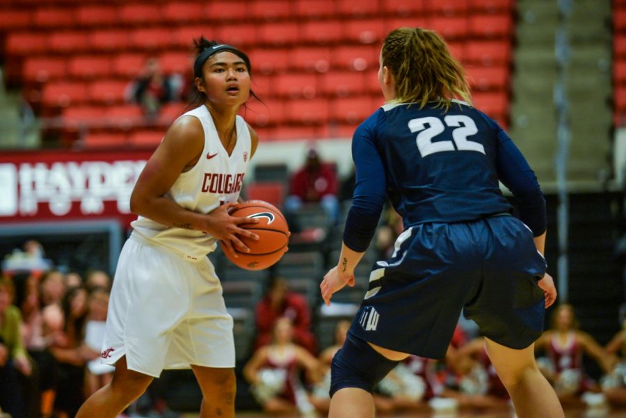 Then-junior guard Chanelle Molina, left, looks past Aggie then-senior guard Rachel Brewster to make a pass during the basketball game against Utah State University on Nov. 6 in Beasley Coliseum. Molina scored 478 points during her junior year. 