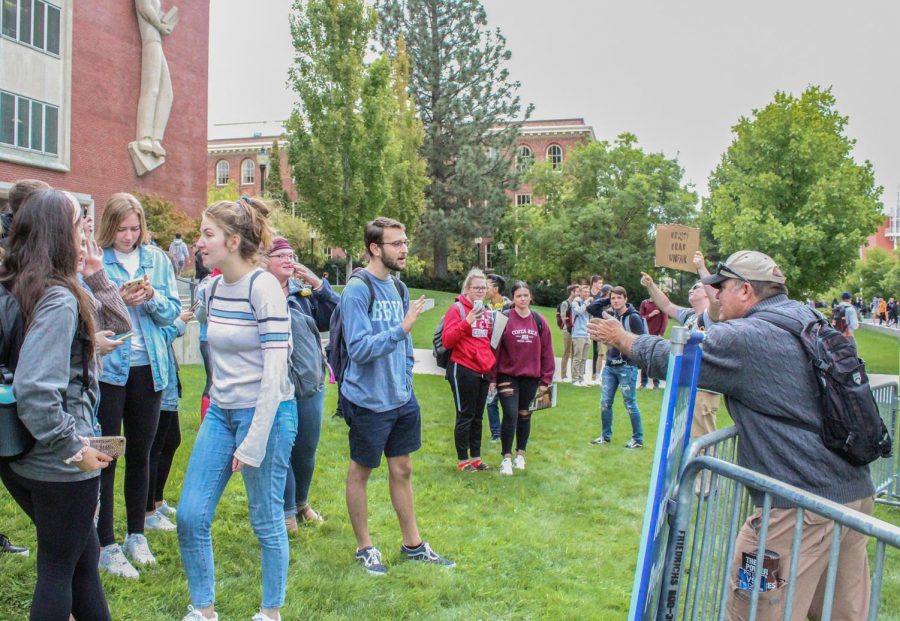 WSU students speak to anti-abortion demonstrators Sept. 16 in front of Bryan Hall.  
The demonstrators sent a letter to WSU stating they would sue the university if needed.