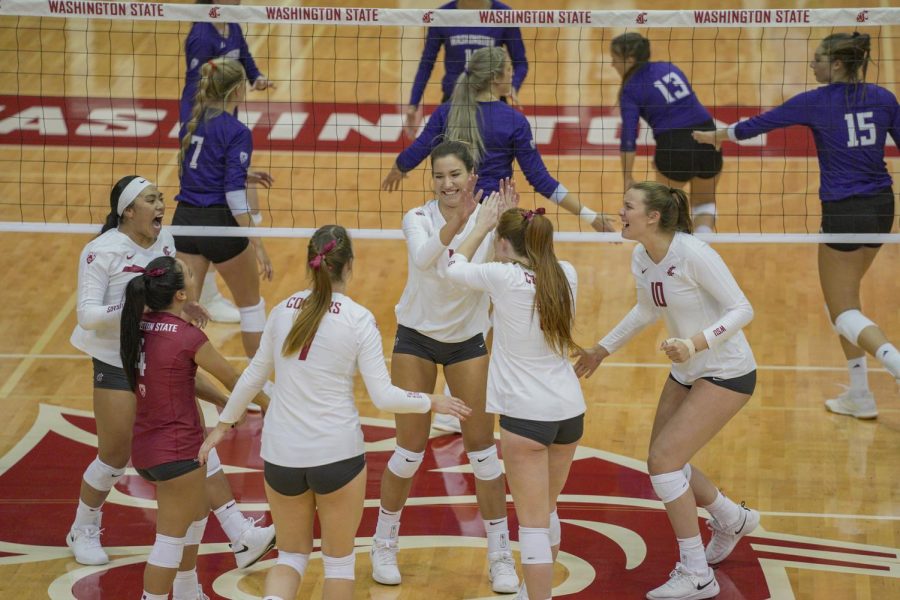 The womens volleyball team celebrates during a match against the University of Washington on Sept. 25, 2019, at Bohler Gym.