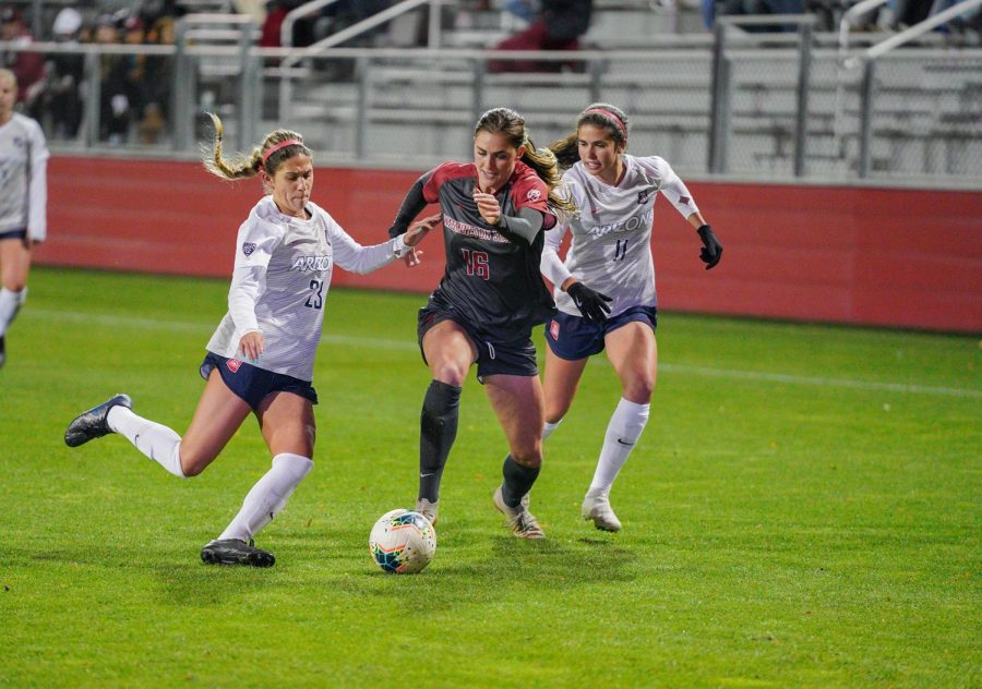 Graduate student midfielder Averie Collins dribbles past Arizona defense on Oct. 10 at the lower soccer fields. 