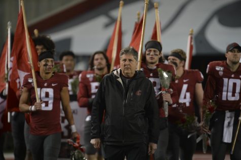 WSU head coach Mike Leach walks ahead of the WSU football seniors as they come onto the field together to be recognized during Senior Night.