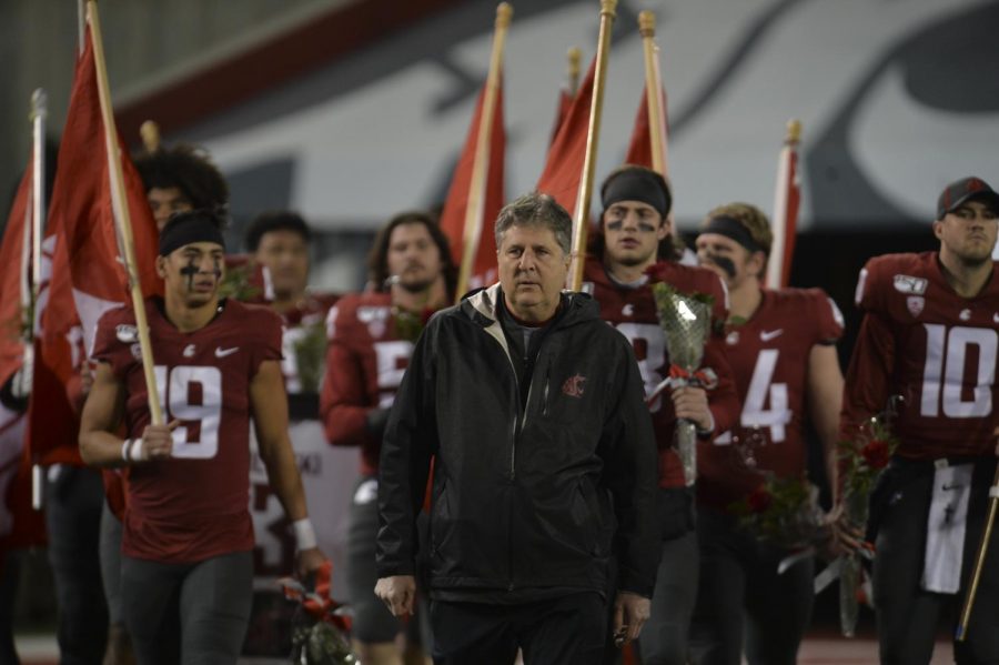 WSU+head+coach+Mike+Leach+walks+ahead+of+the+WSU+football+seniors+as+they+come+onto+the+field+together+to+be+recognized+during+Senior+Night.