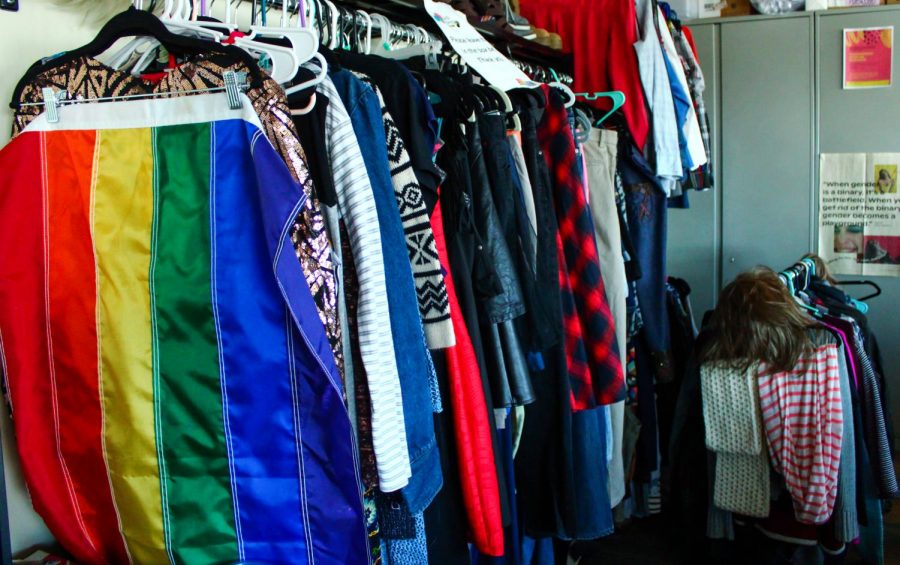 Racks of clothes hang in the Fluid Fashion community closet in the GIESORC office in the CUB. It is open to students, faculty and staff.
