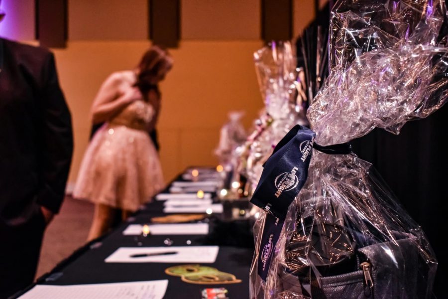 Event attendees look at the silent auction items saturday night at the SEL Event Center. Some of the items included fire themed metal art.