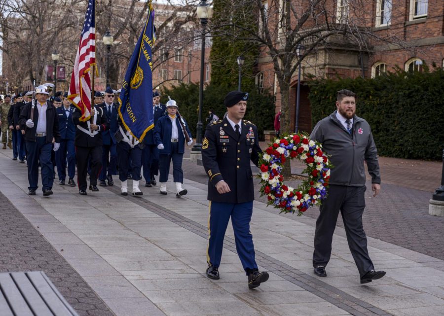 Josh Label, sergeant first class of the University of Idaho ROTC cadre, left, and Chris Mann, President of the WSU veterans committee lead the Pullman American Legion Friday morning on Terrell Mall.