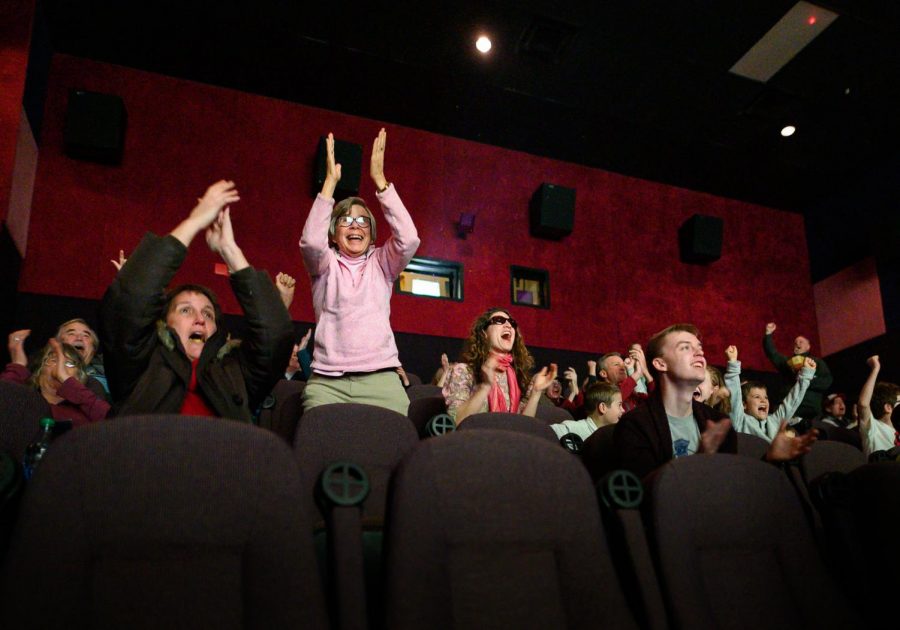 Coug fans cheer and celebrate as Morgan Weaver scores the first goal of the match against North Carolina on Friday evening at Pullman Village Center Cinemas.