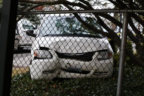 A white Chrysler Town & Country minivan is seen off the road on Friday afternoon near the back entrance to Hillside Cafe.