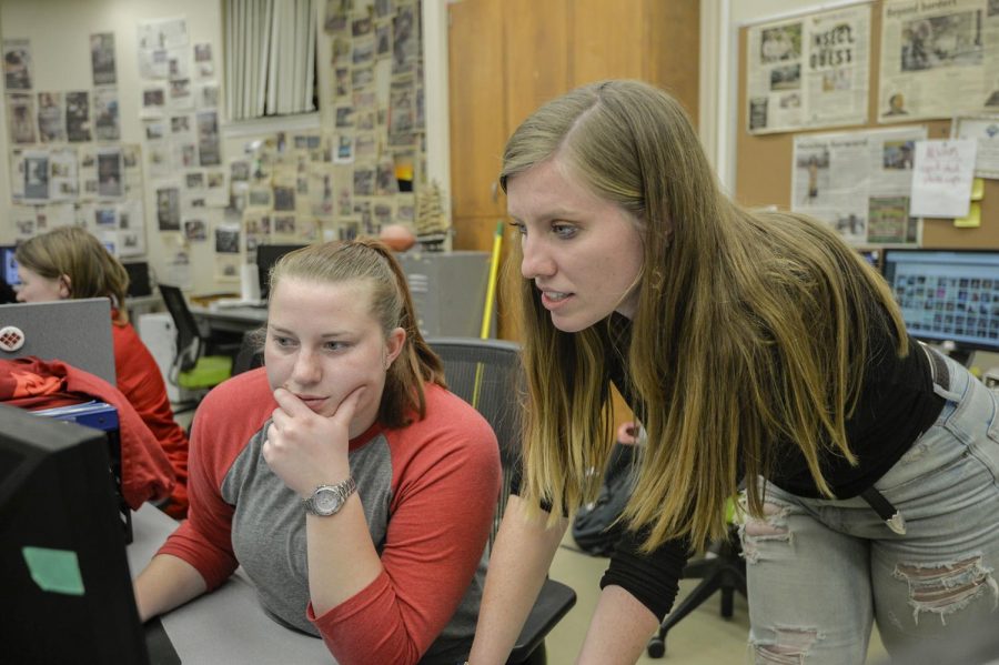 Sports editors Katie Archer, left, and Grace Arnis work on laying out their section for the last paper of the fall semester in The Daily Evergreen newsroom on Thursday.