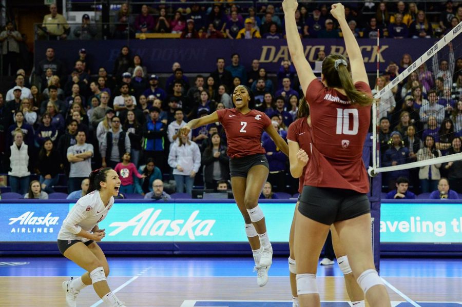 Senior libero Alexis Dirige, left, redshirt freshman outside hitter Kalyah Williams, middle, and freshman outside hitter Alexcis Lusby, right, all celebrate during the Apple Cup win Saturday evening at Alaska Airlines Arena.