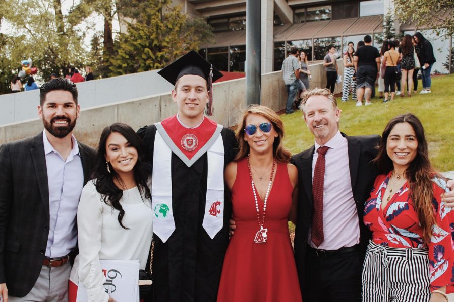 Ryan Pugh, a Daily Evergreen photographer, poses with his family during his commencement ceremony in May. He said he began to grow closer to his coworkers and would look forward to the weekend parties where he would spend time with them. 