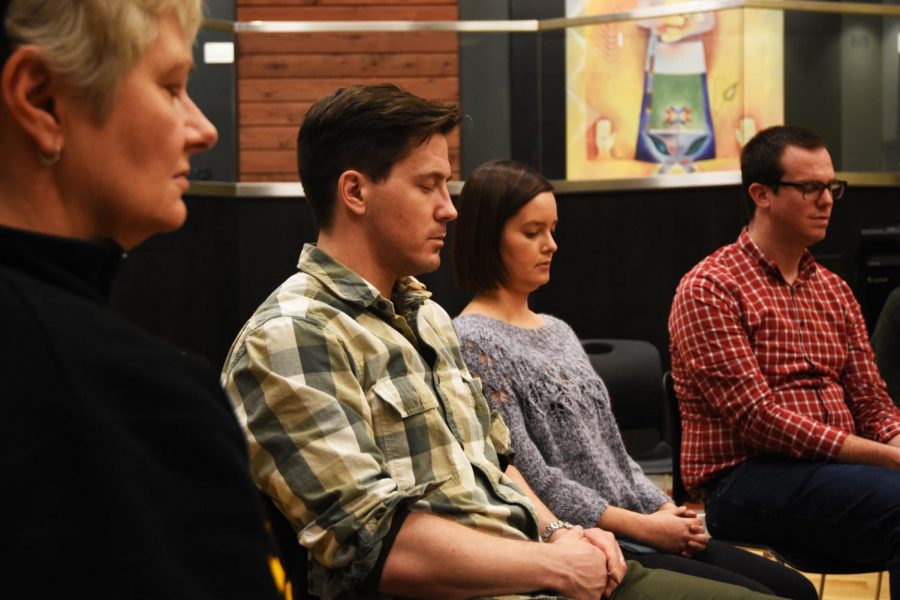 Participants close their eyes and reflect on their current struggles as part of a social justice and mindfulness workshop Monday evening at the Elson S. Floyd Cultural Center. Director of compassion, Cory Custer says mindfulness and compassion equals peace. 