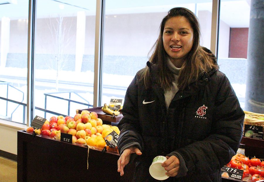Elaily Hernandez-Repreza, a sophomore in criminology and a defense and an athlete on the WSU soccer team, discusses how she saves money by buying mainly white meats, fruits, and vegtables on Monday afternoon at the Northside Market.