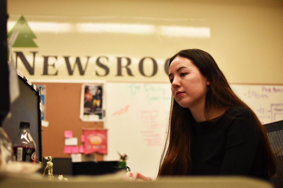 Roots Editor Rachel Sun looks at a rough draft of an article during a readout with reporter Joel Kemegue Friday afternoon in the Evergreen newsroom.