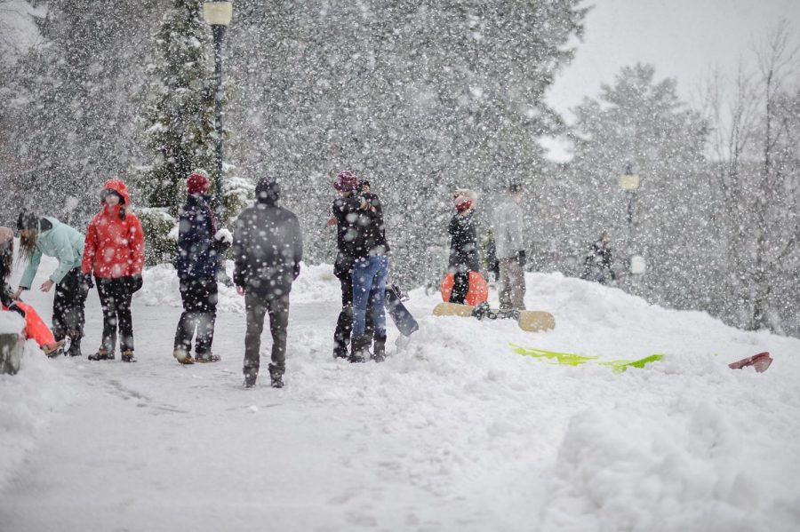 Students gather for sledding and snowboarding before starting the spring semester on Sunday afternoon at Thompson Flats. 