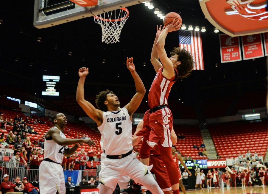Then-freshman+forward+CJ+Elleby+jumps+over+the+Buffaloes+defense+as+he+shoots+during+the+basketball+game+on+Feb.+20%2C+2018+at+Beasley+Coliseum.