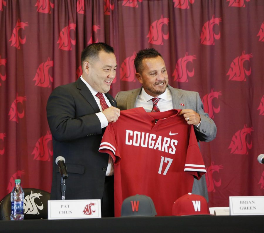 Coach+Brian+Green%2C+right%2C+holds+a+Cougar+jersey+with+WSU+Athletics+Director+Pat+Chun+at+a+press+conference+on+June+5%2C+2019.