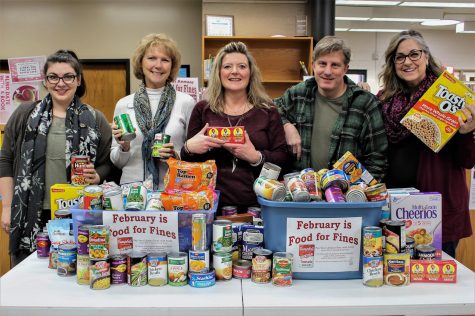 Whitman County staff members Sarah Phelan, Sheri Miller, Nichole Kopp, James Morasch and Kathy Buchholtz pose with donations from the Food for Fines drive.
