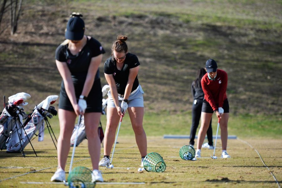 Then-WSU Womens golf teammates senior Madison Odiorne, sophomore Emily Baumgart, and freshman Darcy Habgood set up to range balls during a practice session Monday afternoon at WSUs practice facility. 
