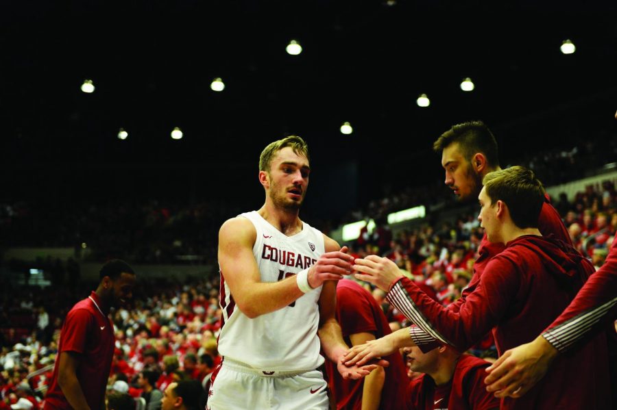 Senior+forward+Jeff+Pollard+high-fives+teamates+as+he+returns+to+the+bench+during+the+game+against+OSU+Jan.+18+at+Beasley+Coliseum.