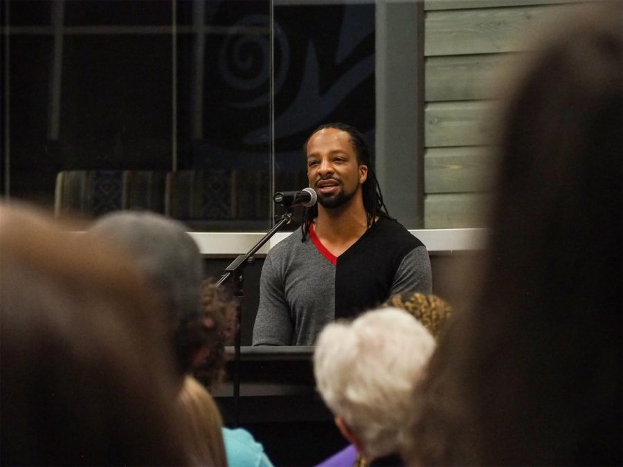 Jericho Brown, poet and associate professor and the director of the Creative Writing Program at Emory University, reads from his poetry during a Visiting Writer event on Thursday evening at the Elson S. Floyd Cultural Center.