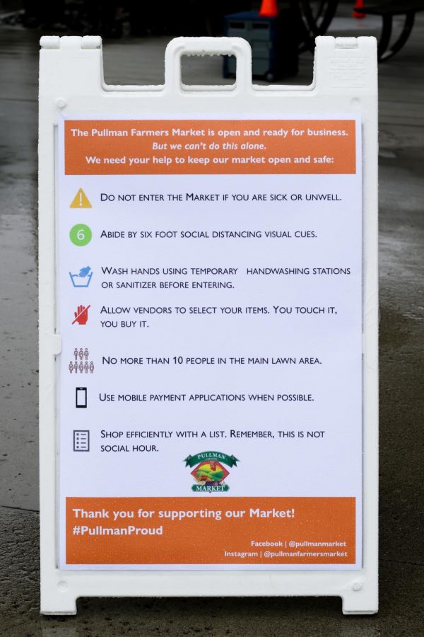 A sign details changes to operations due to coronavirus at the entrance to the Pullman Farmers Market.
