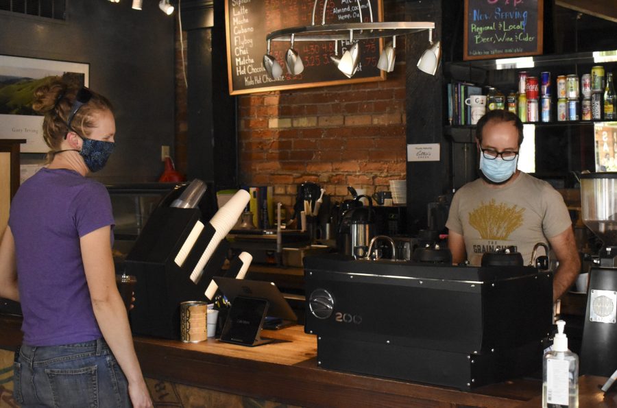 Owner Tyson Feasel works behind the counter at Café Moro on Friday morning. The coffee shop will close on August 20.