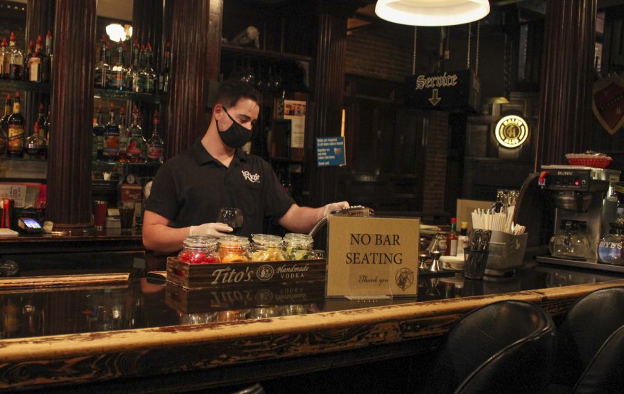 Cameron McKinley fixes a drink behind the bar Wednesday evening at Ricos Pub.