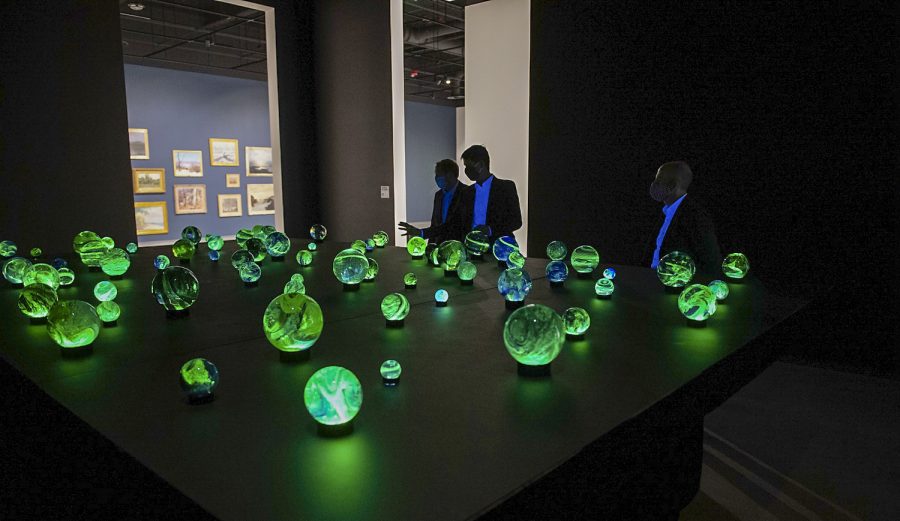Visitors view the orbs made from glass and a low level of uranium.