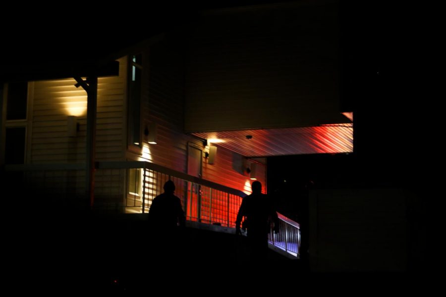Two police offers approach the Delta Delta Delta house on Halloween night.