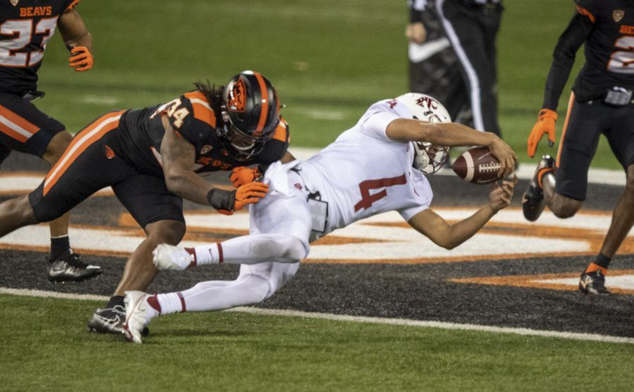 True freshman quarterback Jayden de Laura dives into the endzone to extend the Cougars lead to 21-7 during the football game against Oregon State on Saturday.