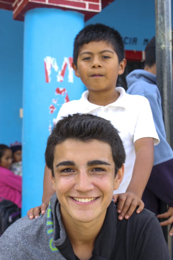 Sam spoke Spanish to and played soccer with the children in the town where he volunteered.