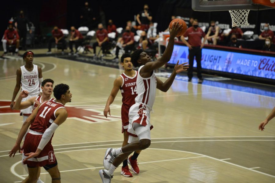 Driving+to+the+hoop+around+Stanford%E2%80%99s+defense%2C+freshman+guard+TJ+Bamba+makes+a+layup+during+the+game+Saturday+afternoon+in+Beasley+Coliseum.